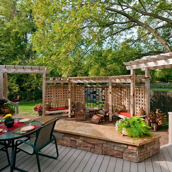 This playful and unique outdoor living space literally blends in with the home's wooded back yard