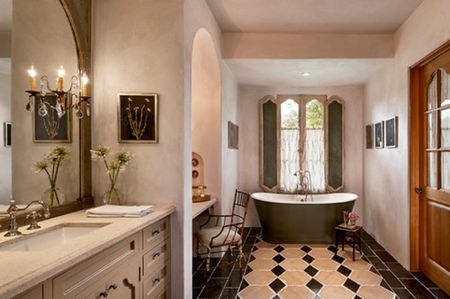 The bathroom features stylish flooring and sink along with its pendant lights