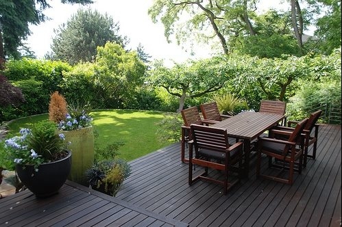 Covered Back Deck With Concrete Floor And Outdoor Furniture