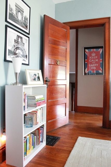 home office, custom desk solution, dark wood trim and  desk, medium wood floors, light teal wall color, no window treatments