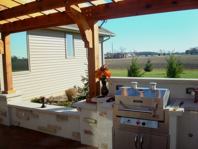 A small backyard in San Diego, California offers a BBQ Island with a grill, sink, and lots of counter space