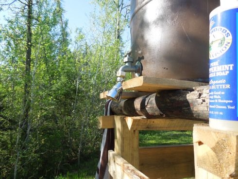 To the right is the  thermosiphoning passive solar water heater, which supplies hot water to our outdoor  shower