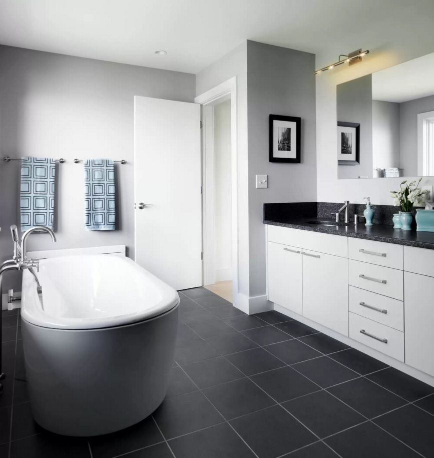 I love everything about this bathroom! The black herringbone floor, the  white subway tiles with black grout and the frameless shower doors