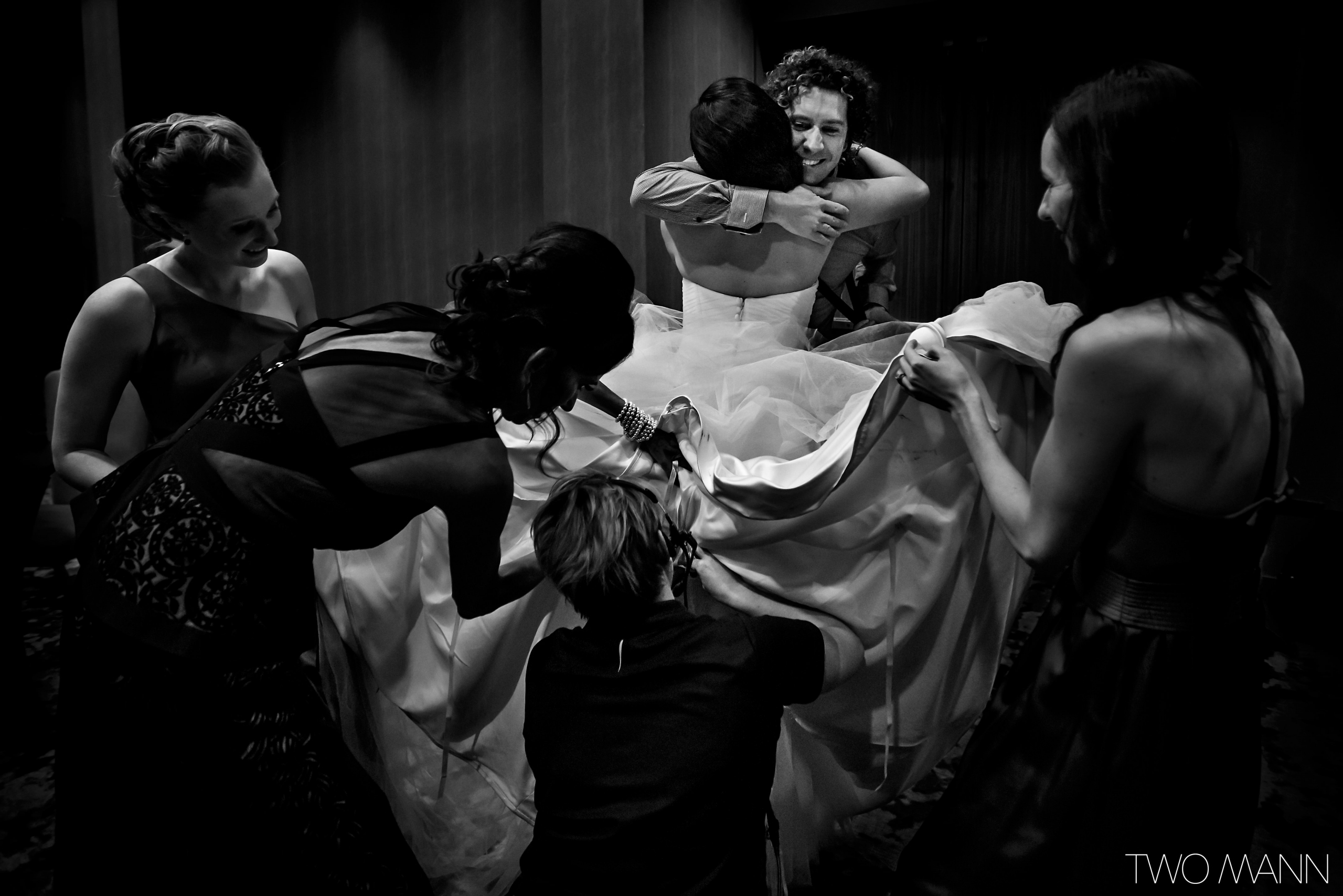 a groom shaving face in front of a mirror