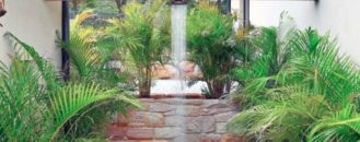 Natural Cobbles Covered Outdoor Shower Area with Wall Mounted Bench