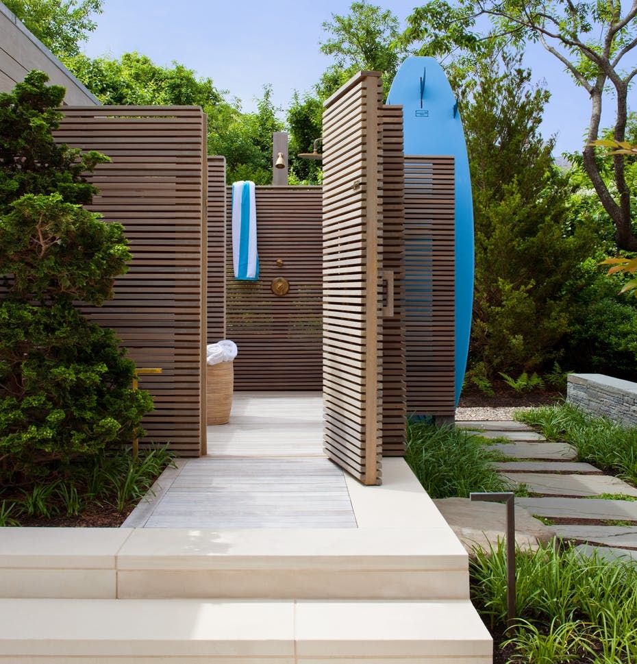 An outdoor bathroom featuring an open shower area with a private courtyard