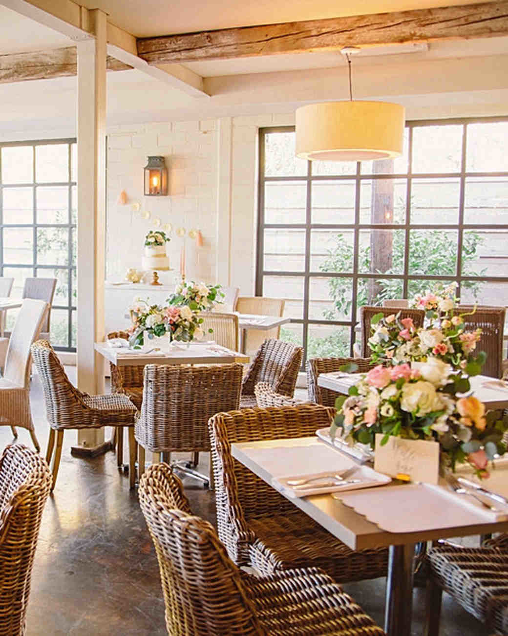 outdoor bridal shower · White drapes surrounding long bridal shower table with flower table runner and parasols overhead