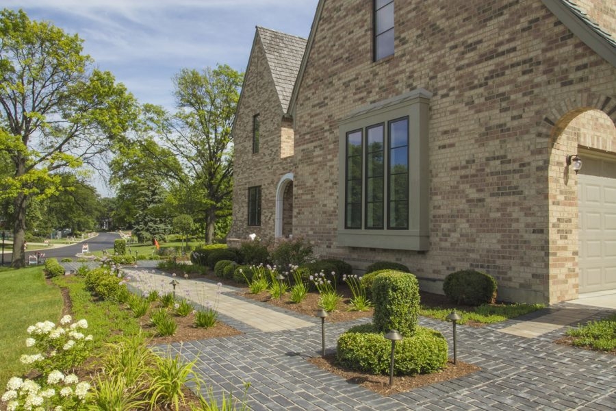 , by Saussy Burbank, boosts its curb appeal with a generous front  porch on two levels that signals a welcoming place and relaxed outdoor  living